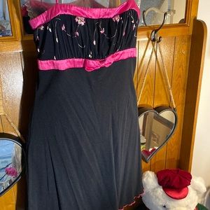 This is a very cute dress. It’s black with hot pink flowers and  satin ribbon.